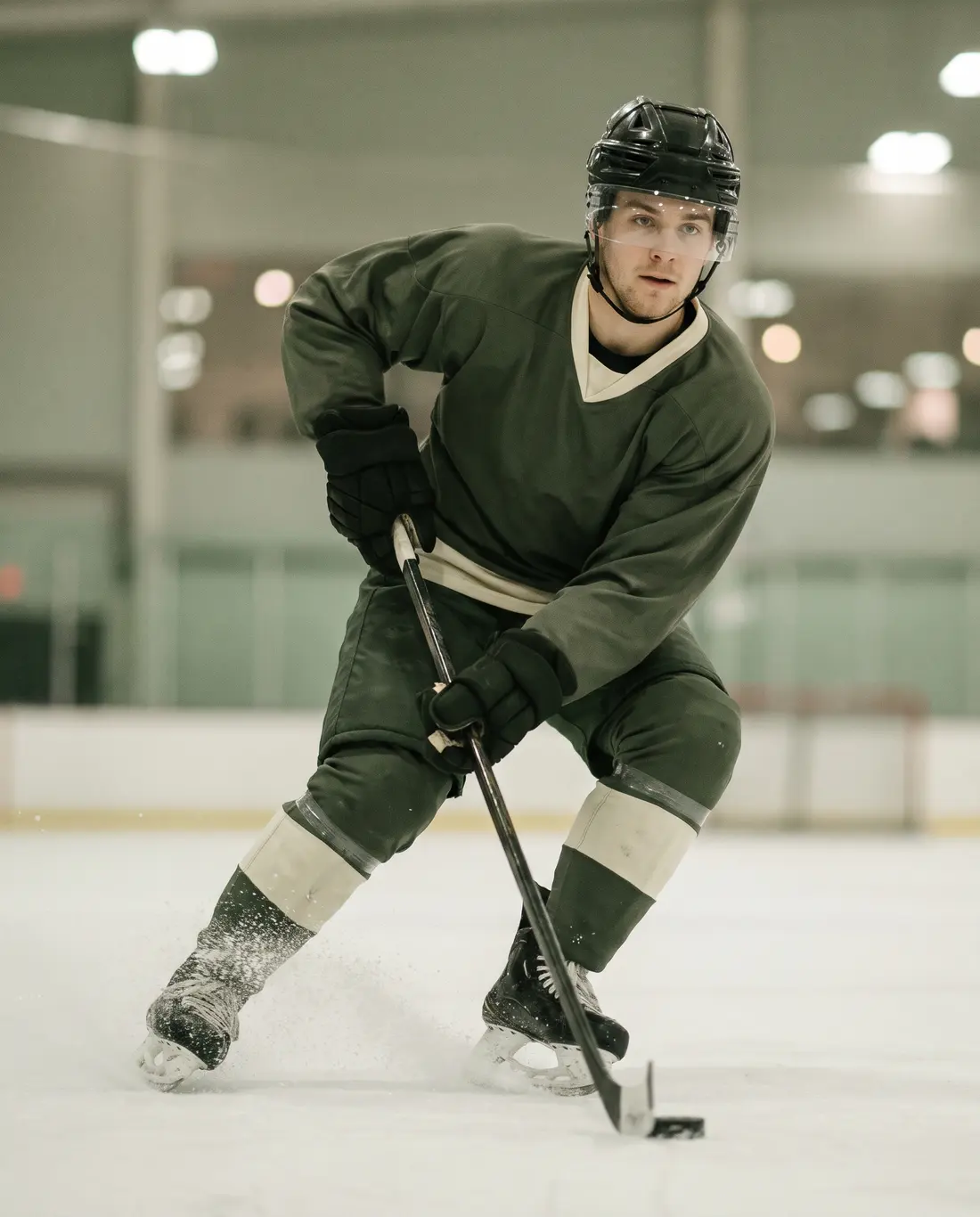 A hockey player skating hard with the puck
